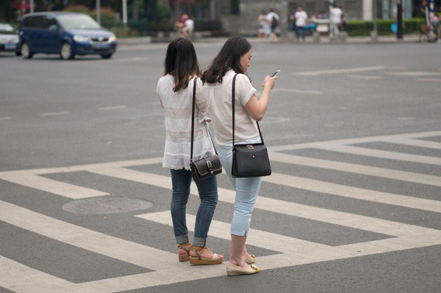 Trung Quốc phạt tiền người đi bộ xem điện thoại khi sang đường - Ảnh 1.